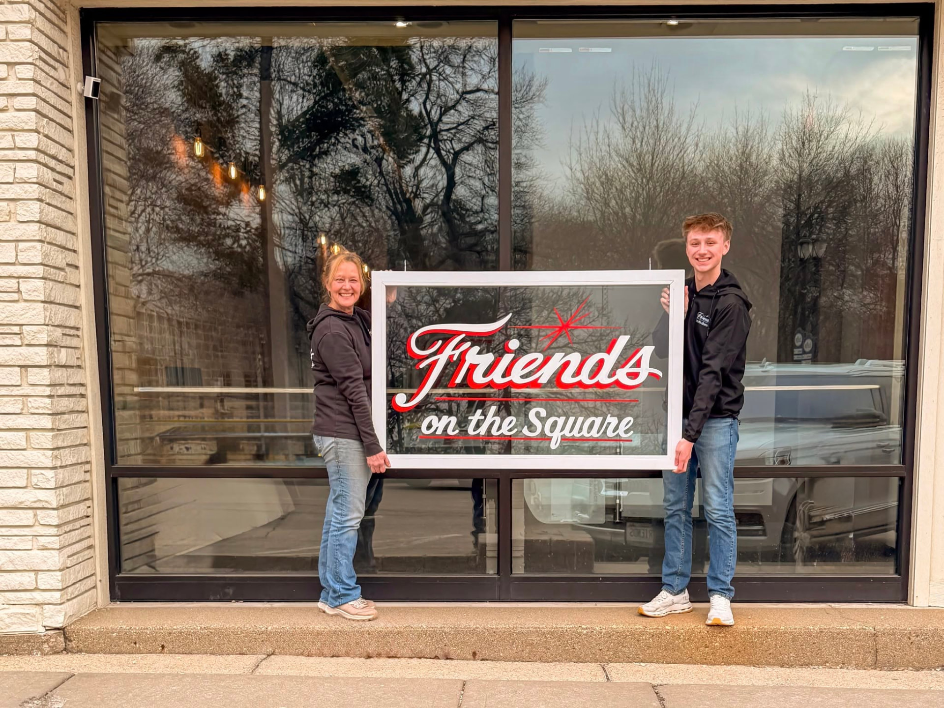 David Redford and former owner Kelly Odling with the Friends Coffee Company hand-painted sign